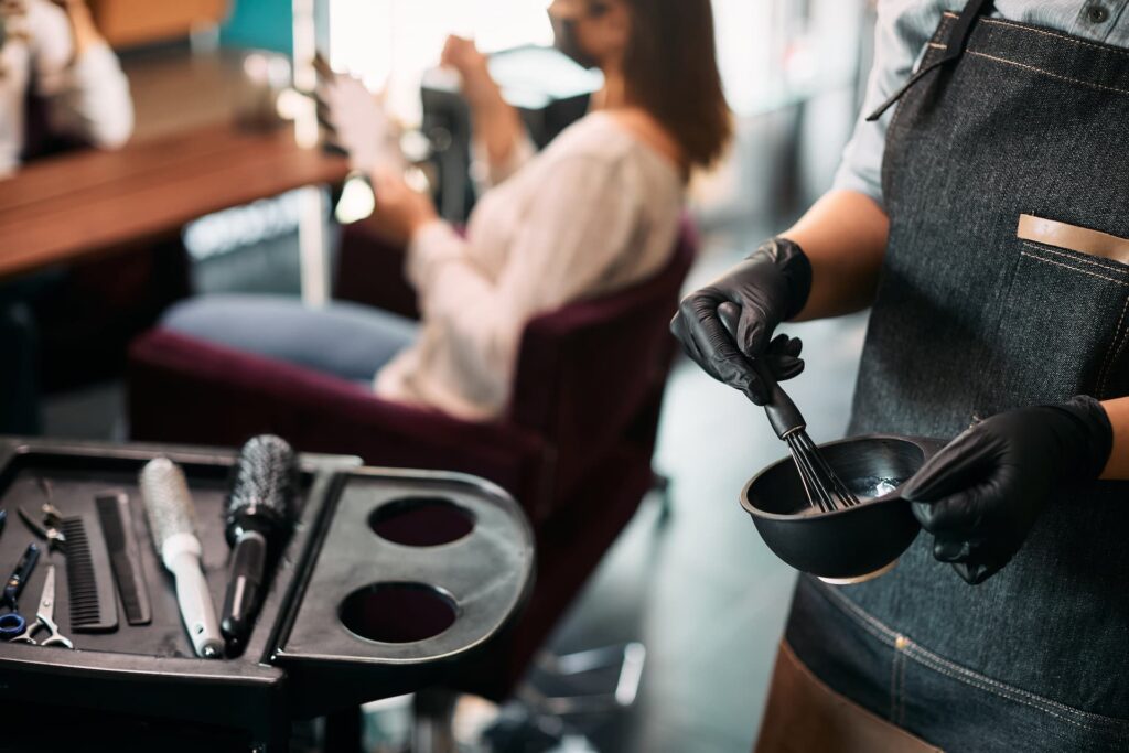 close up of hairstylist mixing hair dye while work 2024 12 13 20 30 07 utc1
